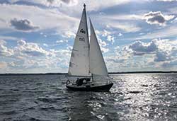 black sailboat on the water